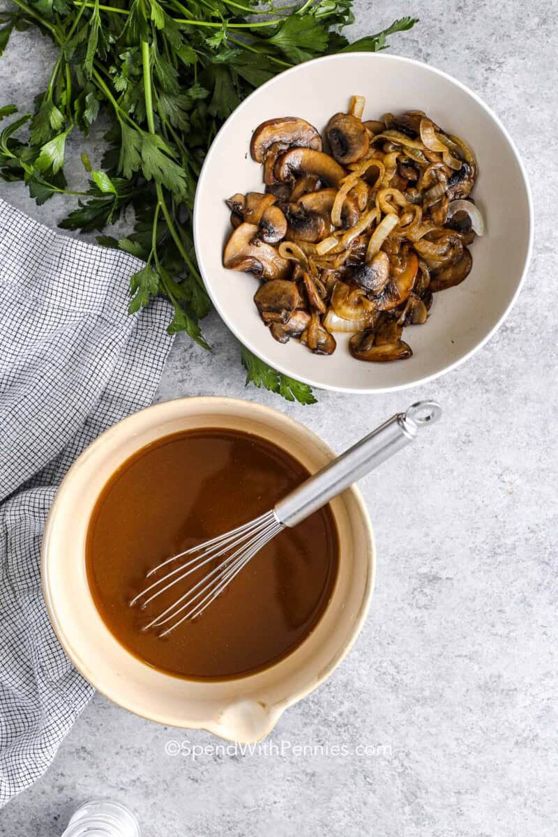 cooked mushrooms and onions in a bowl and sauce for salisbury steak in another bowl