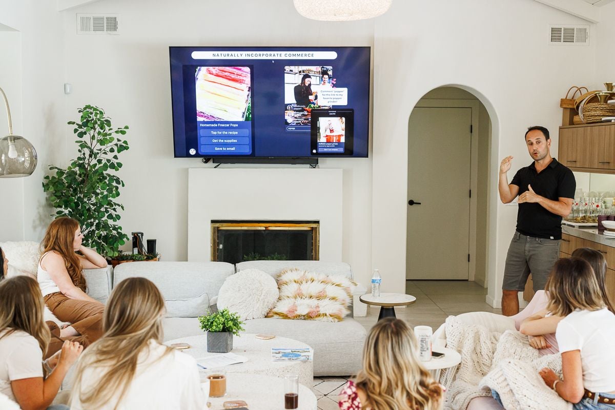 Girls sitting in a living room listening to a presentation about Grocer's List