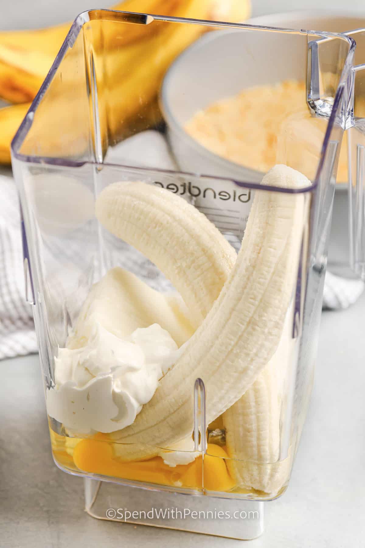 bananas, eggs, cream cheese, and sour cream in a blender for banana pudding cheesecake