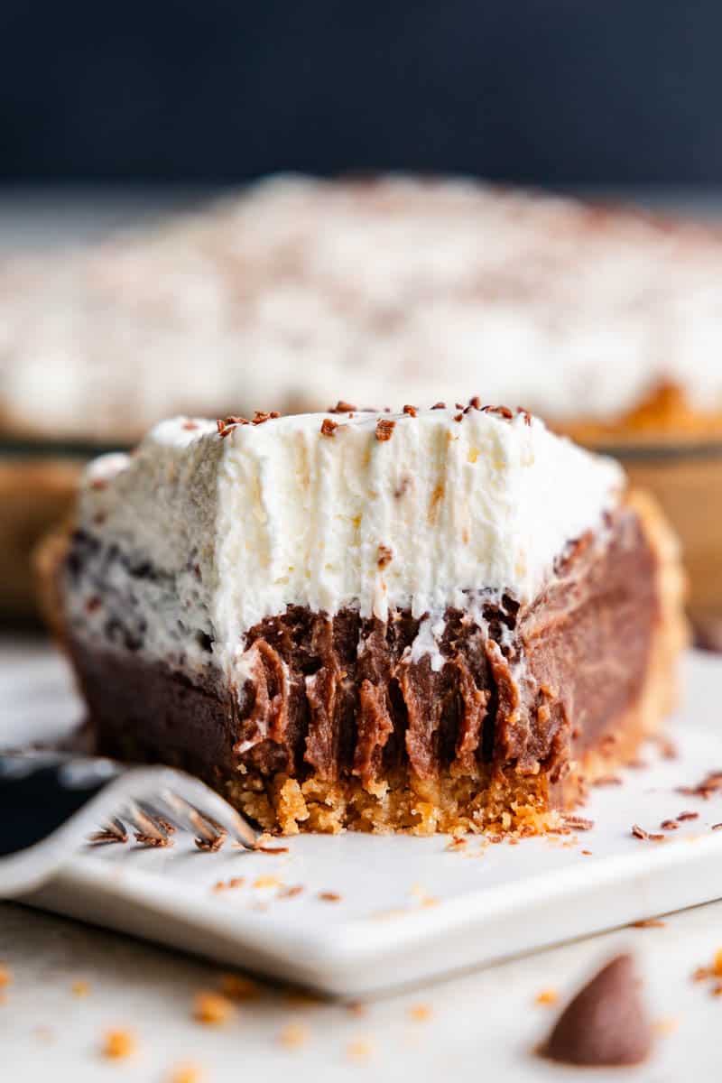 slice of chocolate cream pie on plate with bite taken out of it