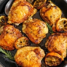 skillet of Skillet Chicken Thighs with one on a spoon