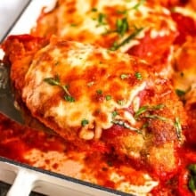 serving a baked chicken parmesan from a casserole dish