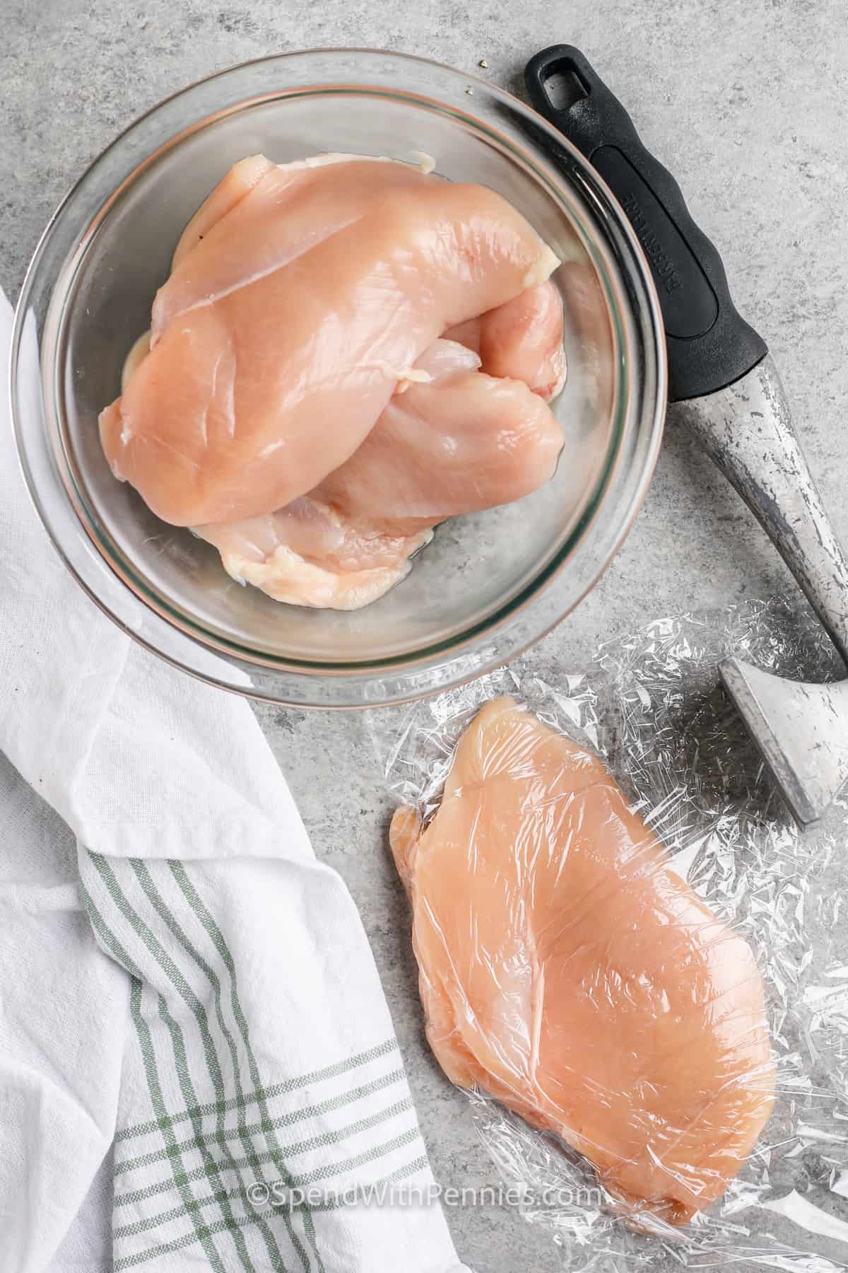 flattening chicken to make Easy Chicken Parmesan