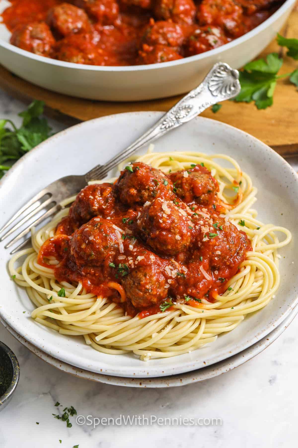 Easy Meatball Recipe in the pan and on spaghetti with sauce