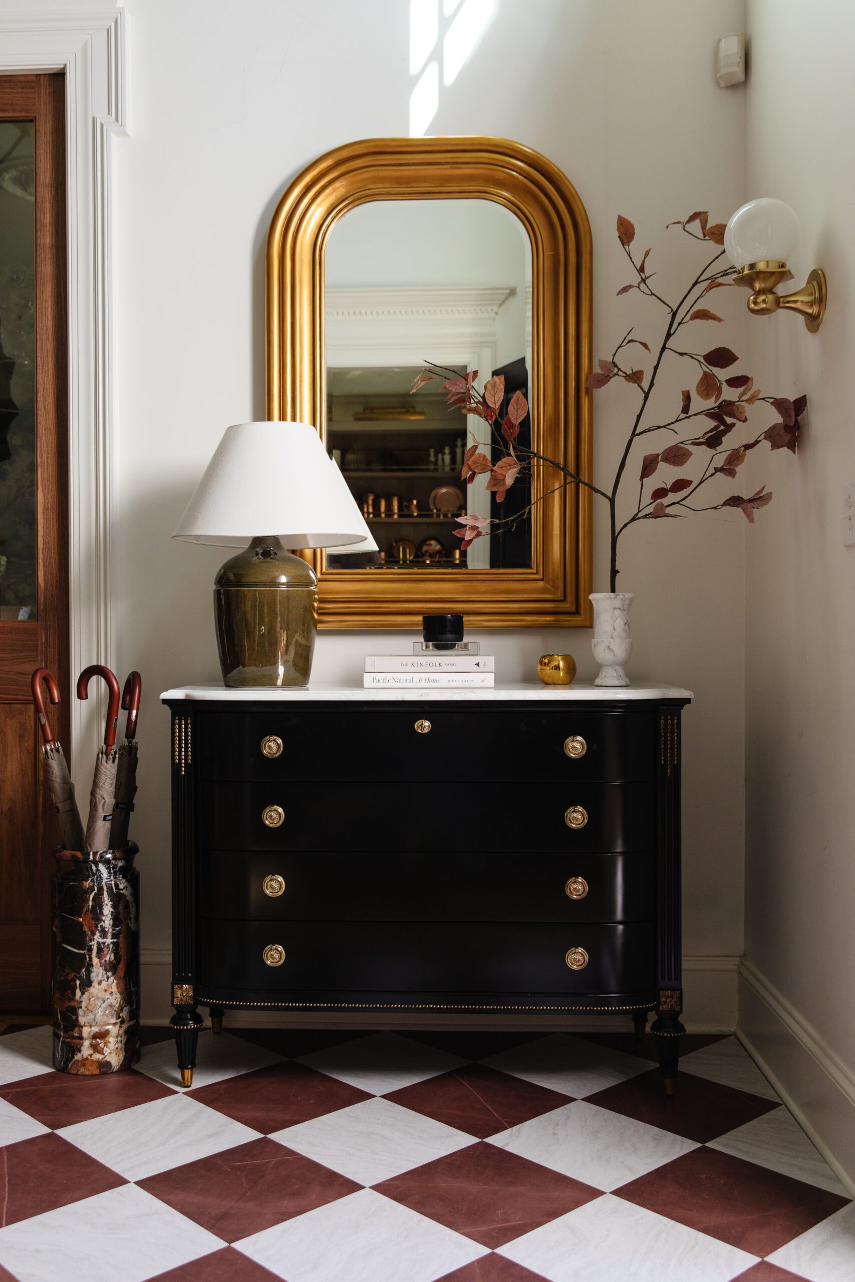 A front entry dresser featuring tiles in red & white marble checkerboard