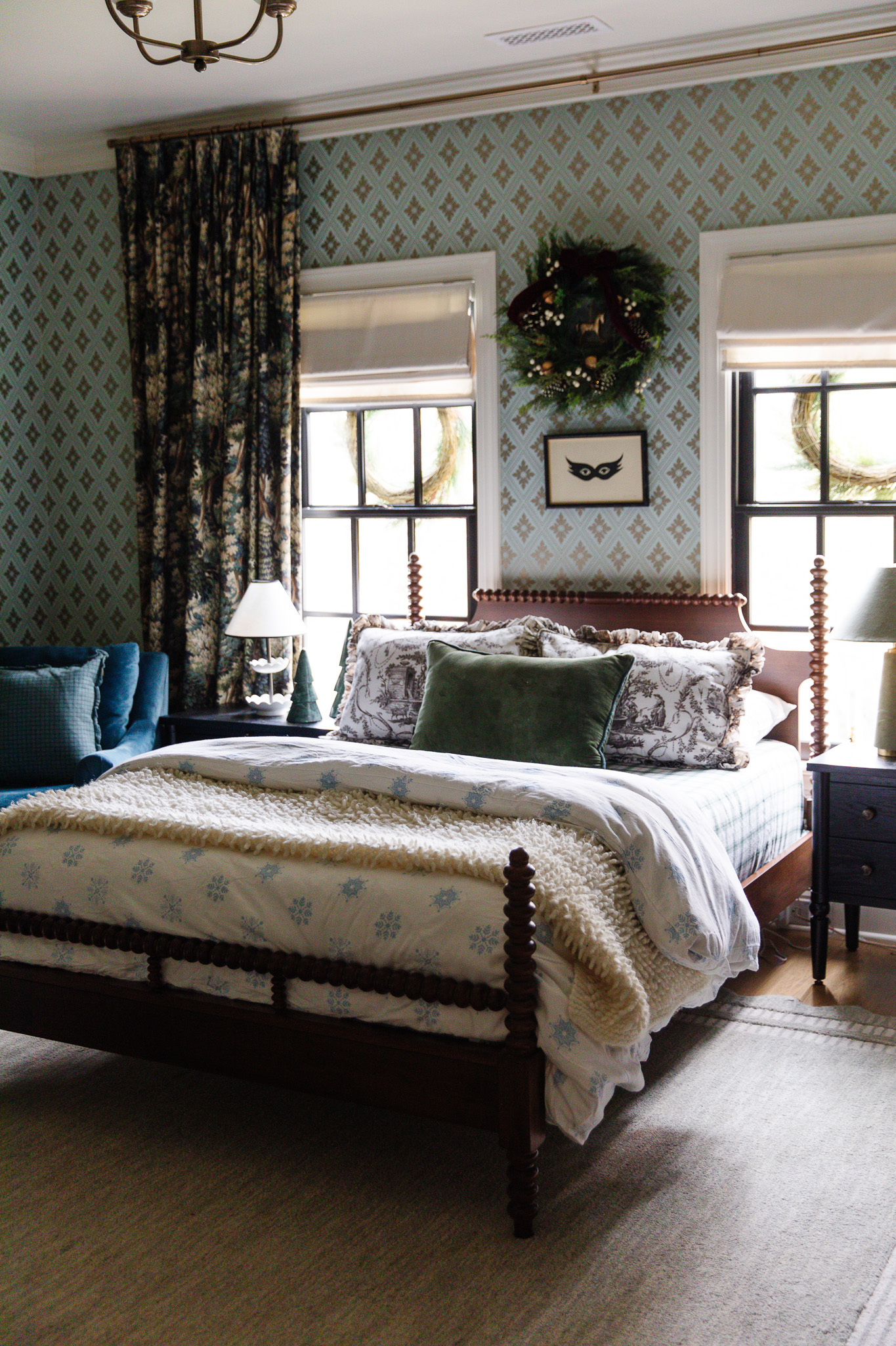 Faye's blue-gold room with a lush wreath with gold accents over the bed