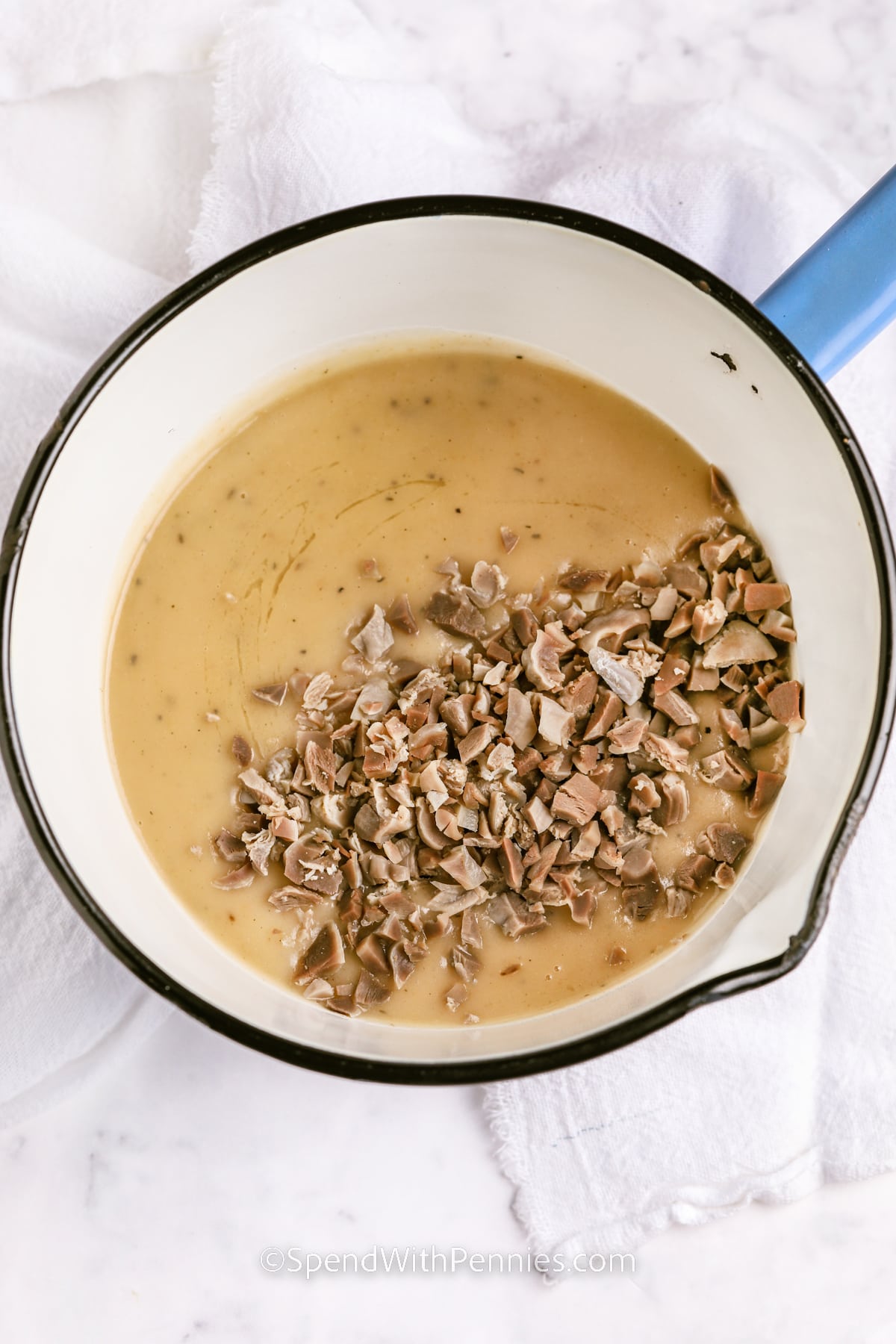 adding turkey to pot to make Giblet Gravy