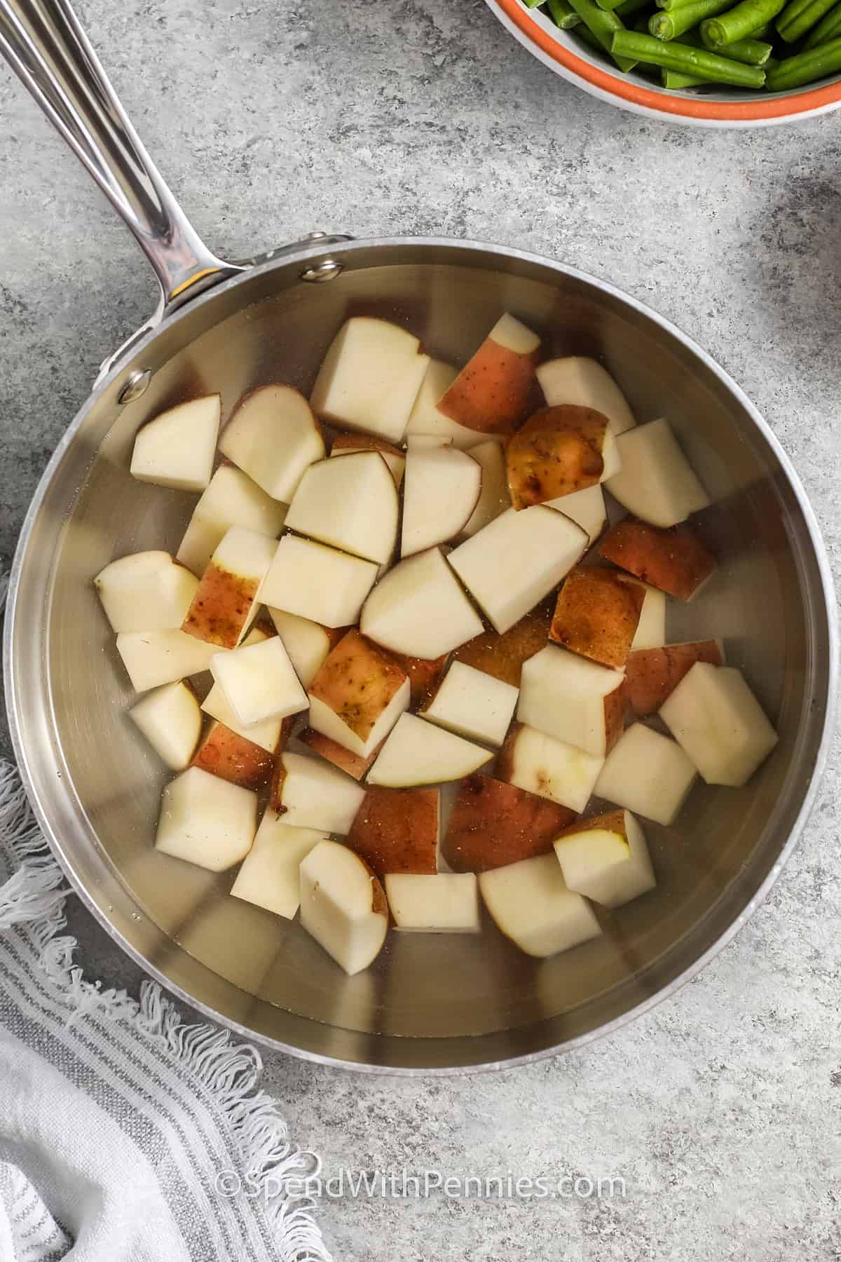 cooking potatoes to make Green Beans and Potatoes