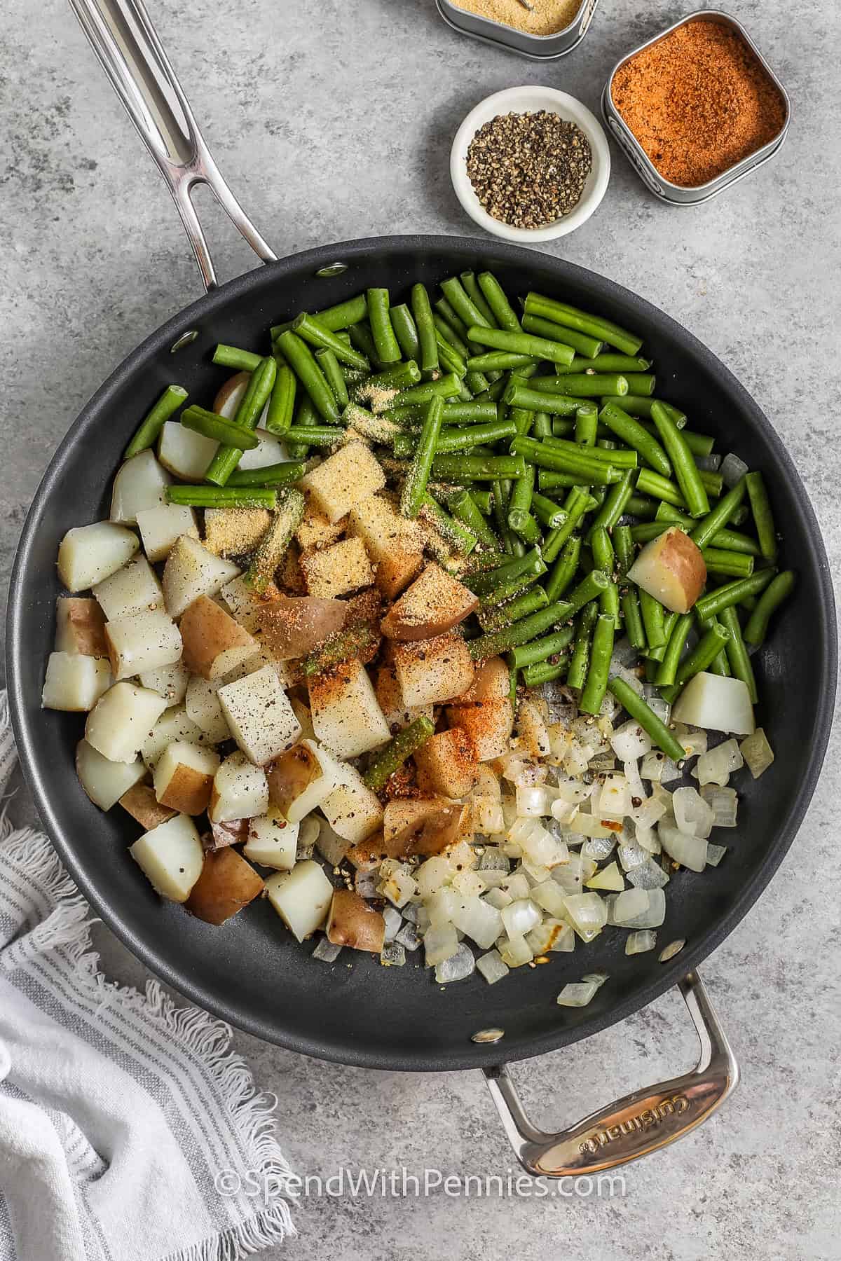 adding ingredients to pan to make Green Beans and Potatoes