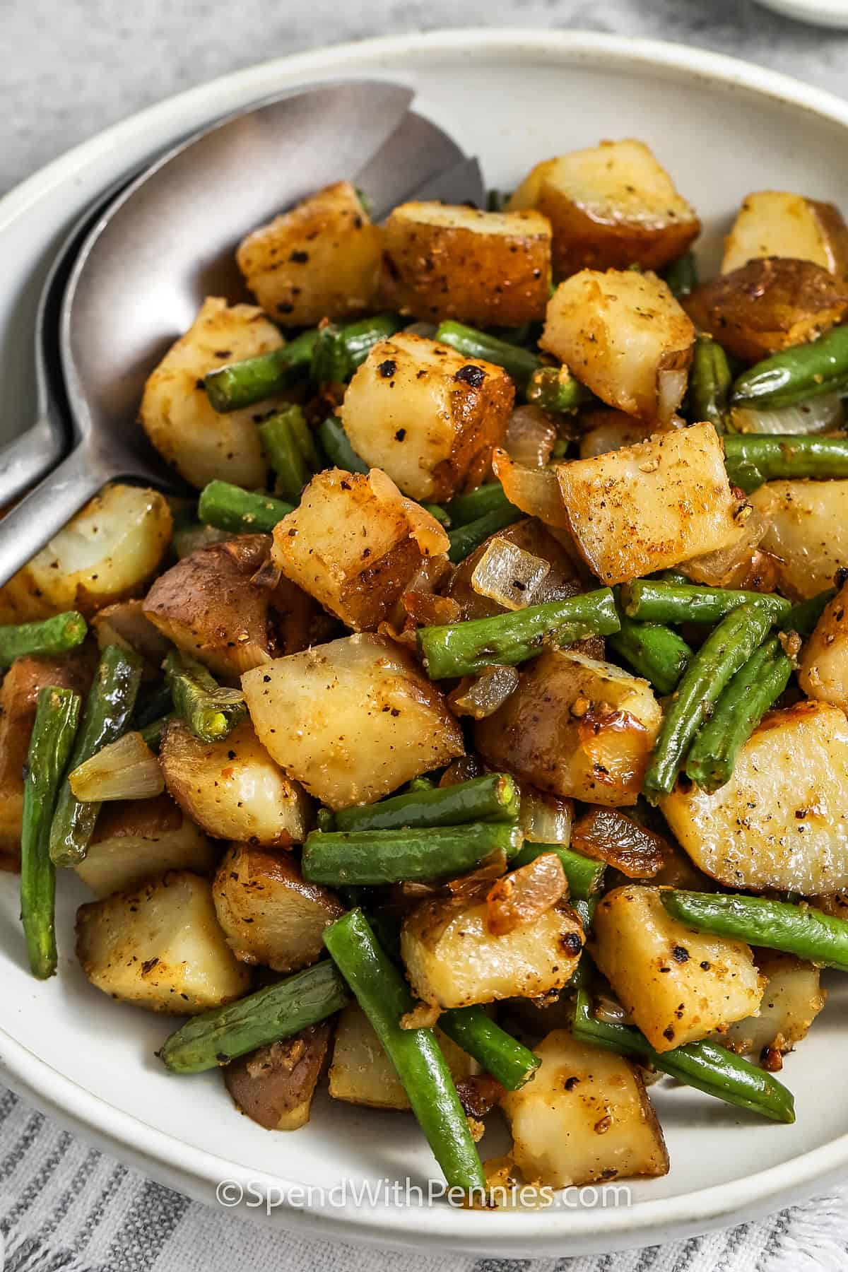 plate of Green Beans and Potatoes with spoons