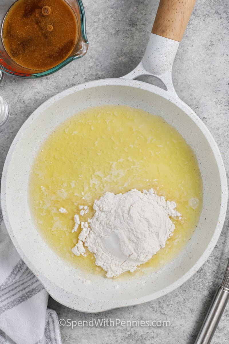 adding flour to melted butter to make Ham Gravy