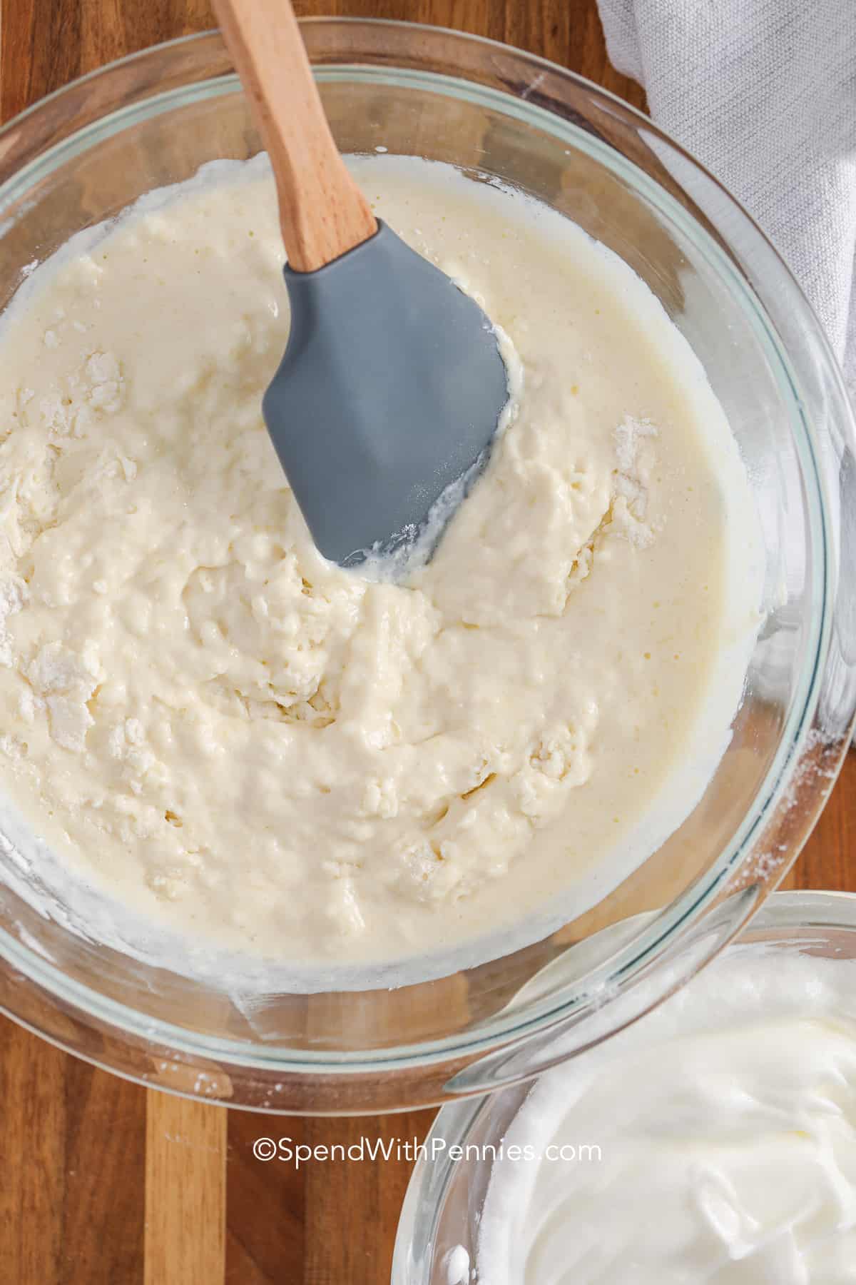 mixing waffle recipe batter in a bowl