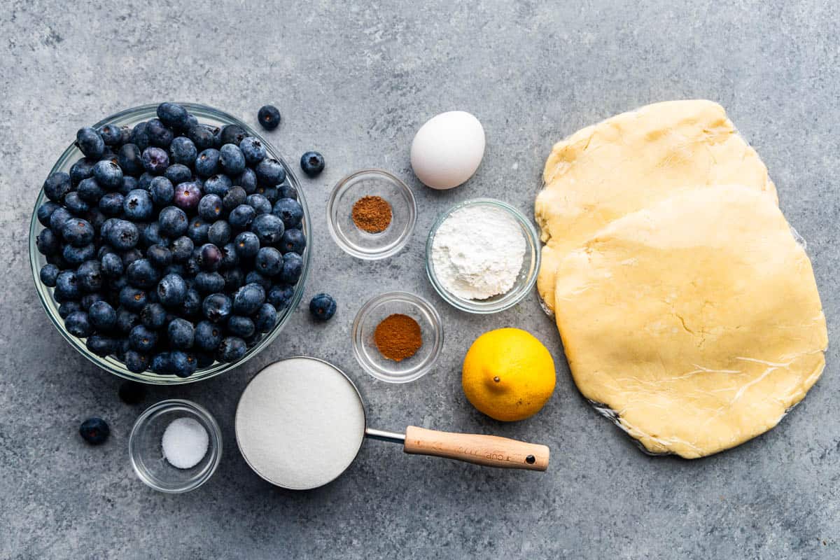 An overhead view of the ingredients needed to make blueberry pie.