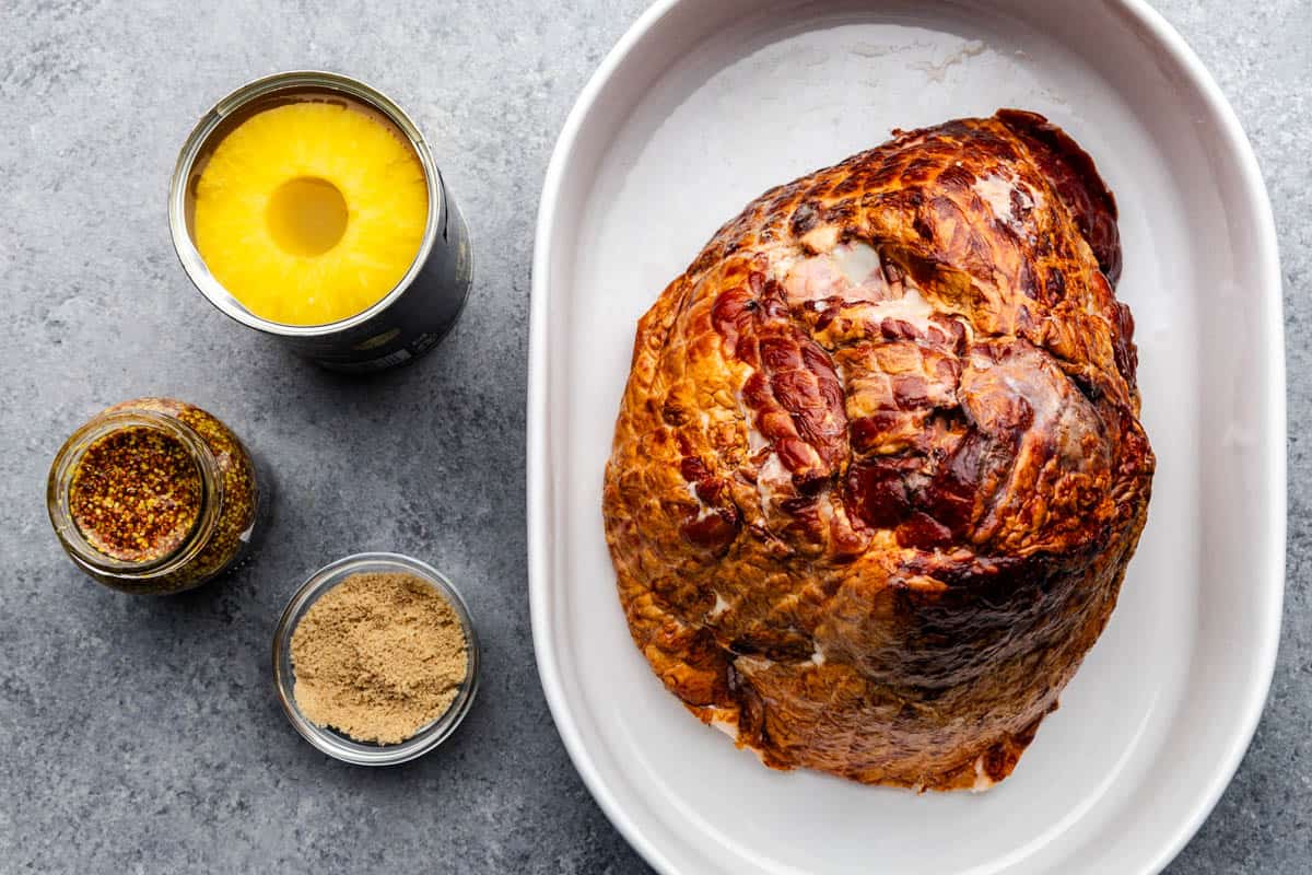 An overhead view of a full ham and ingredients to make savory pulled ham.