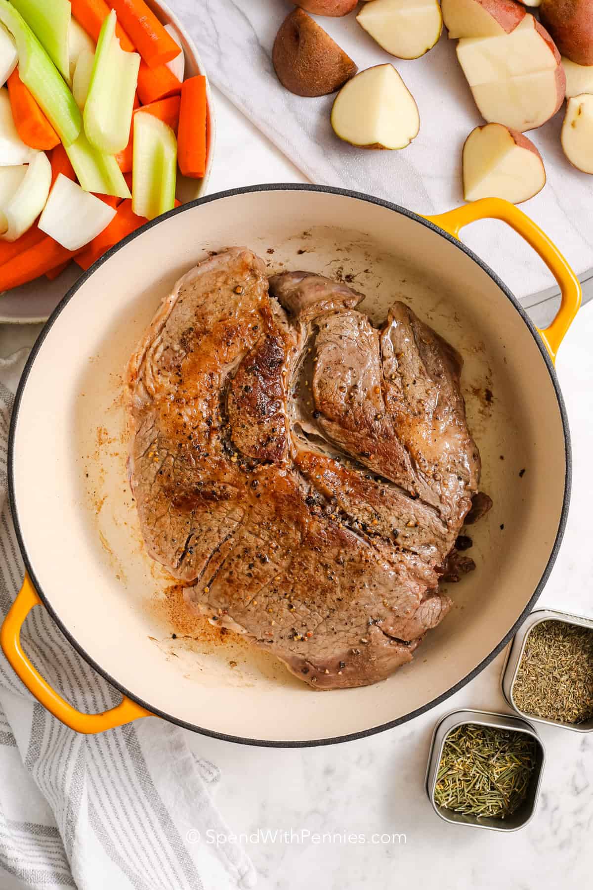 a seared pot roast in a Dutch oven