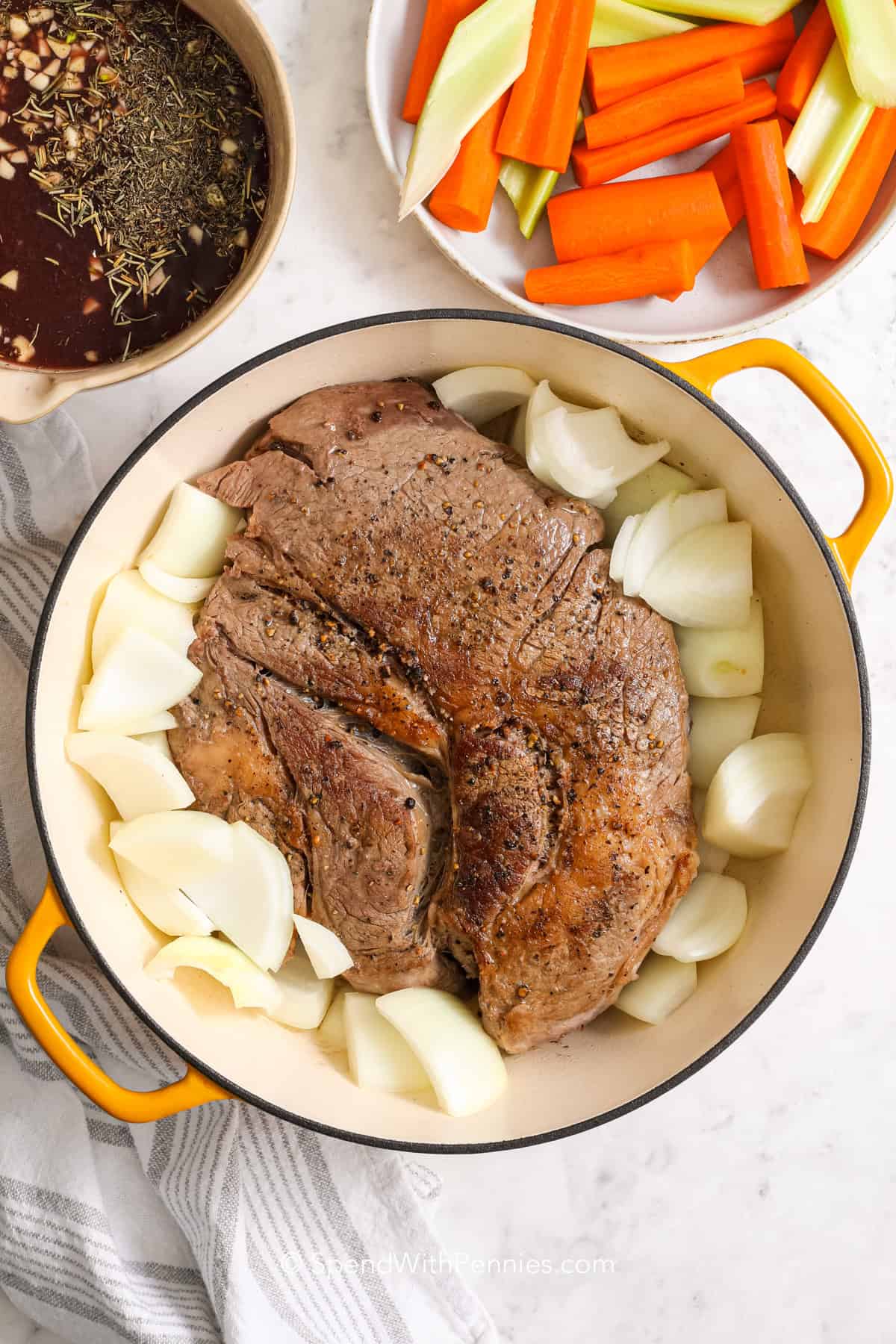 a seared pot roast with onions in a Dutch oven 