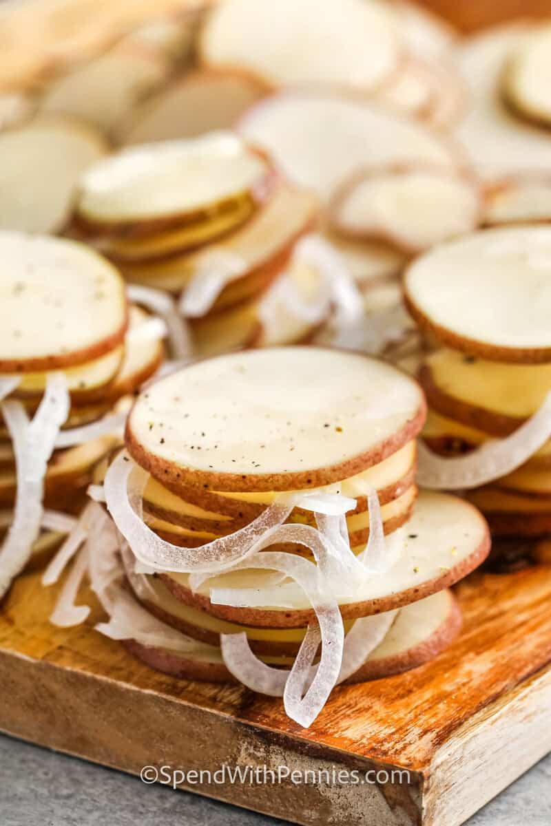 A small stack of sliced potatoes and onions for potatoes au gratin