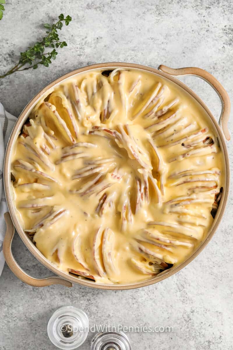 Unbaked potatoes au gratin in a dish