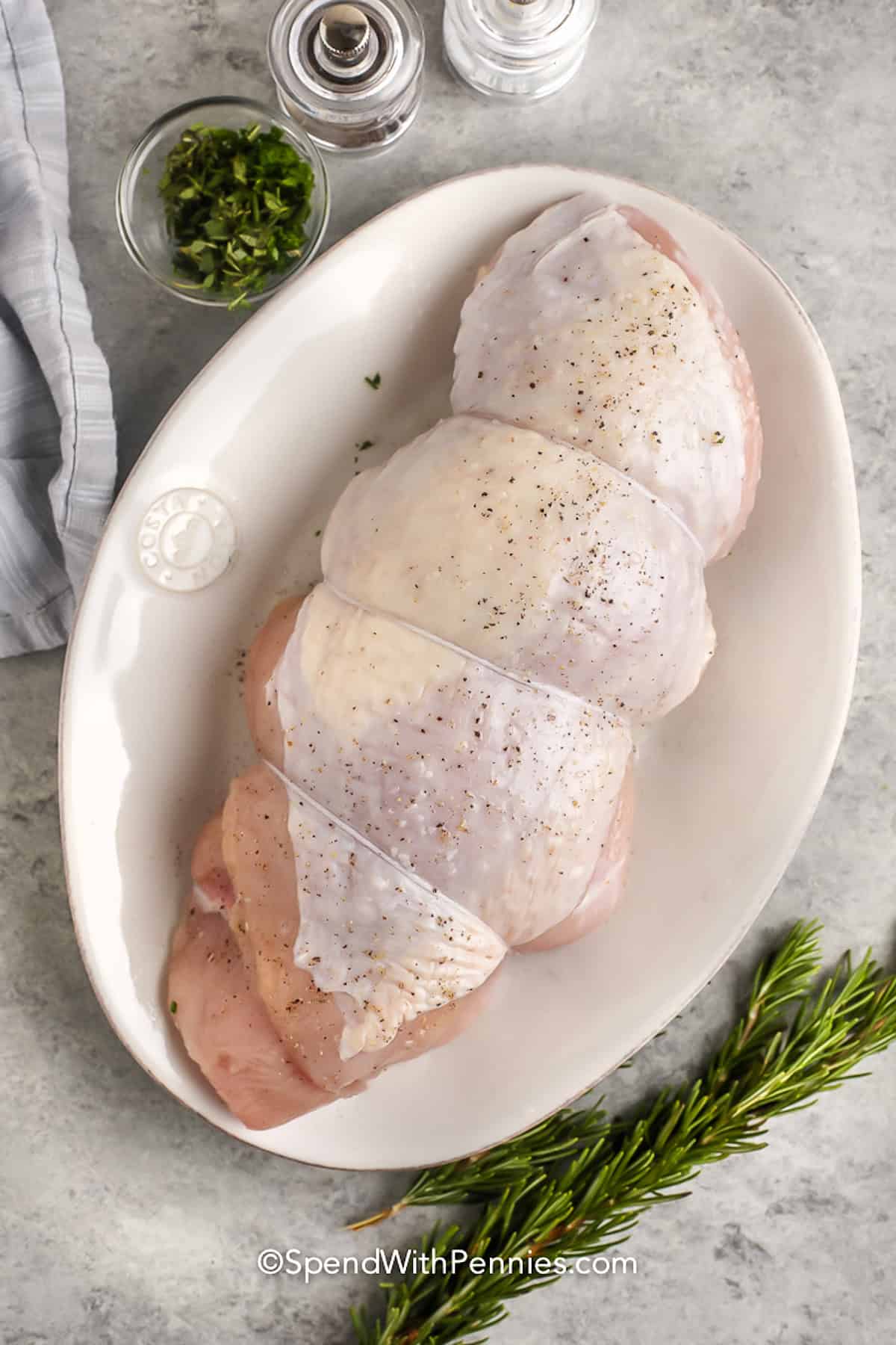 seasoned turkey on a plate to make Roast Turkey Breast