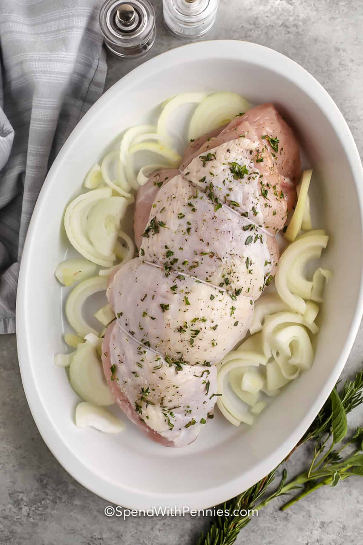 adding onions to pot with turkey to make Roast Turkey Breast