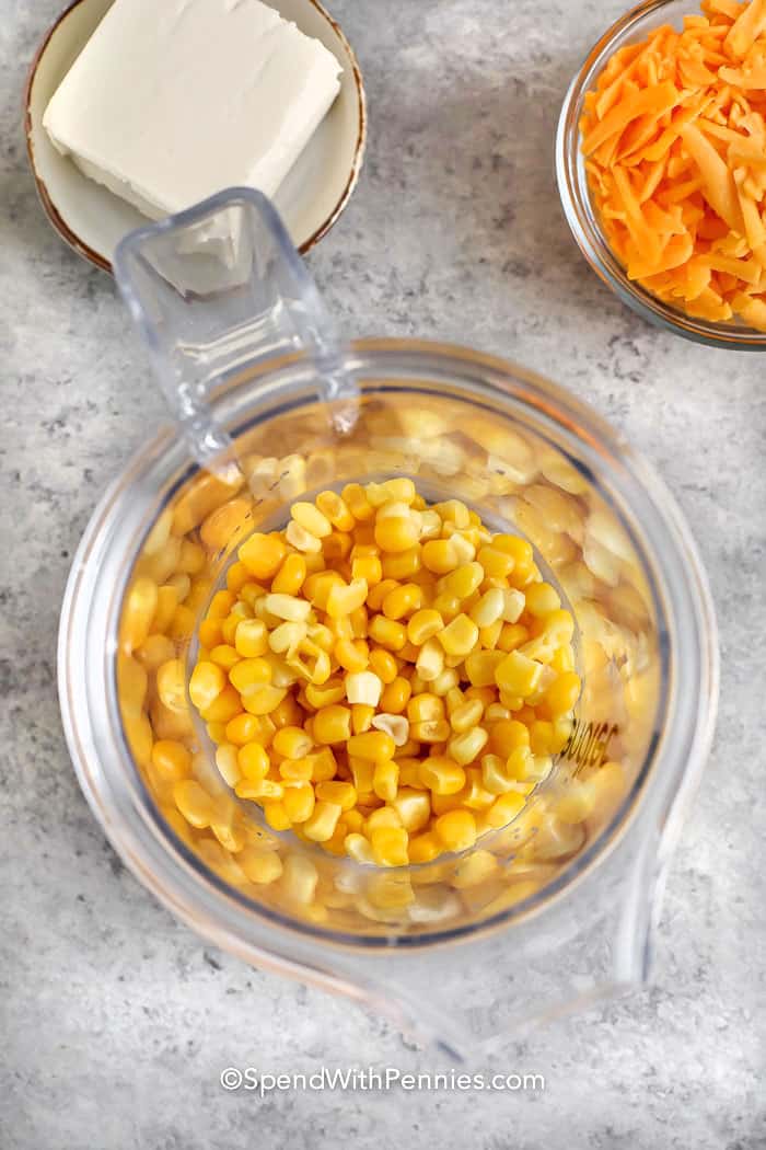 adding corn to food processor to make Crock Pot Creamed Corn