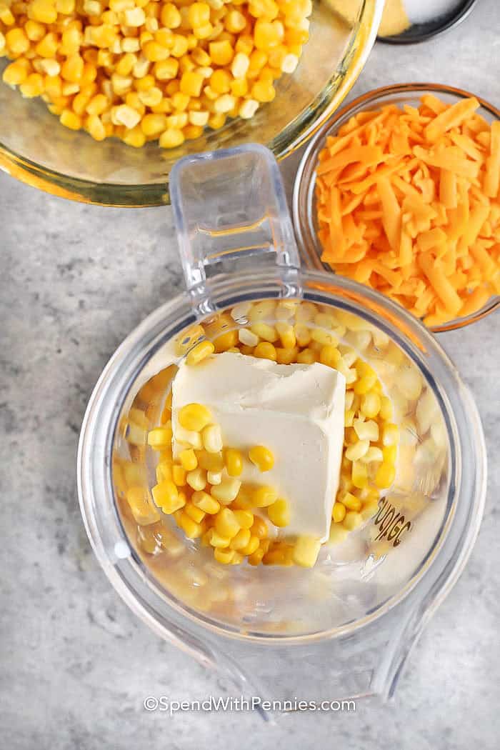 adding cream cheese to corn to make Crock Pot Creamed Corn