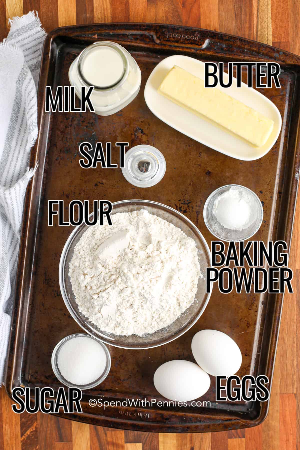 Ingredients for homemade waffle recipe on a wood board