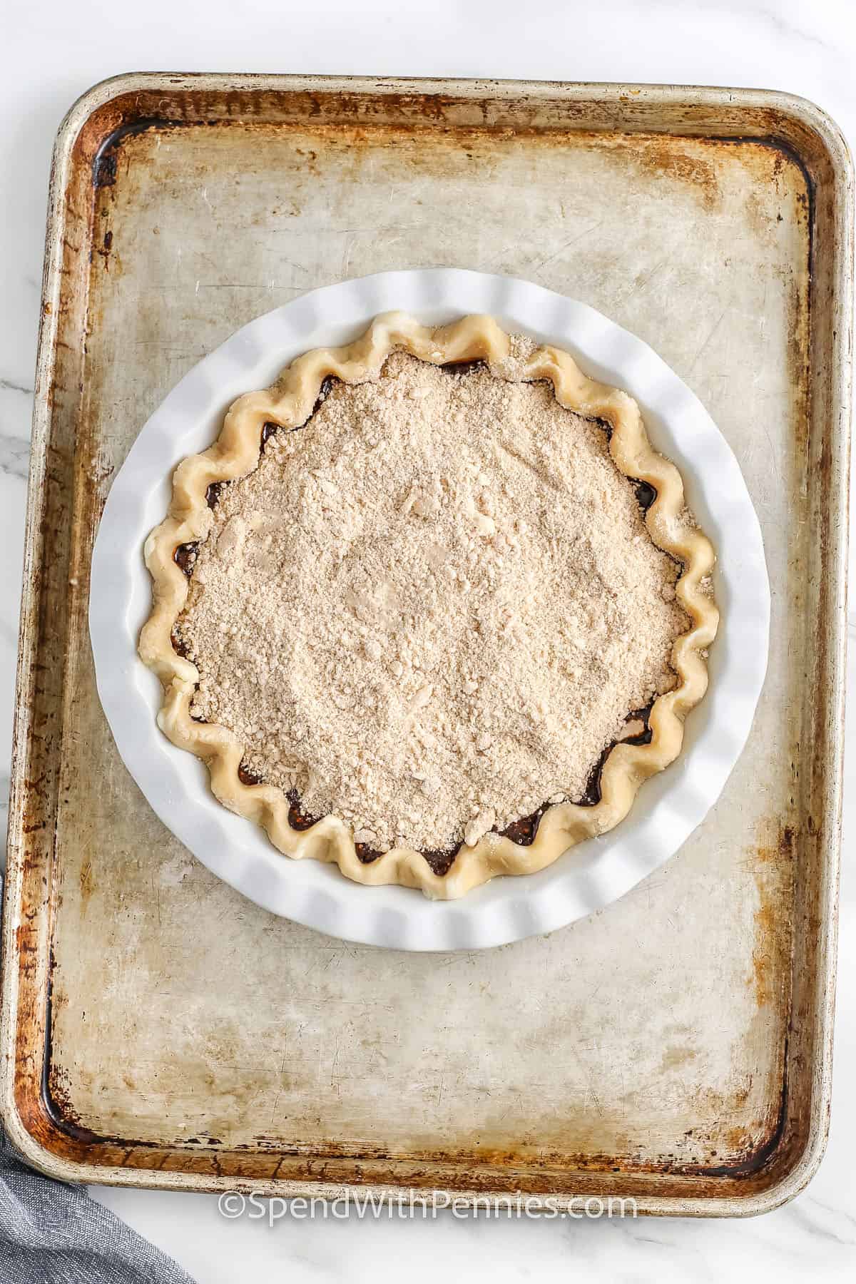 Shoofly Pie on a sheet pan and pie dish before baking