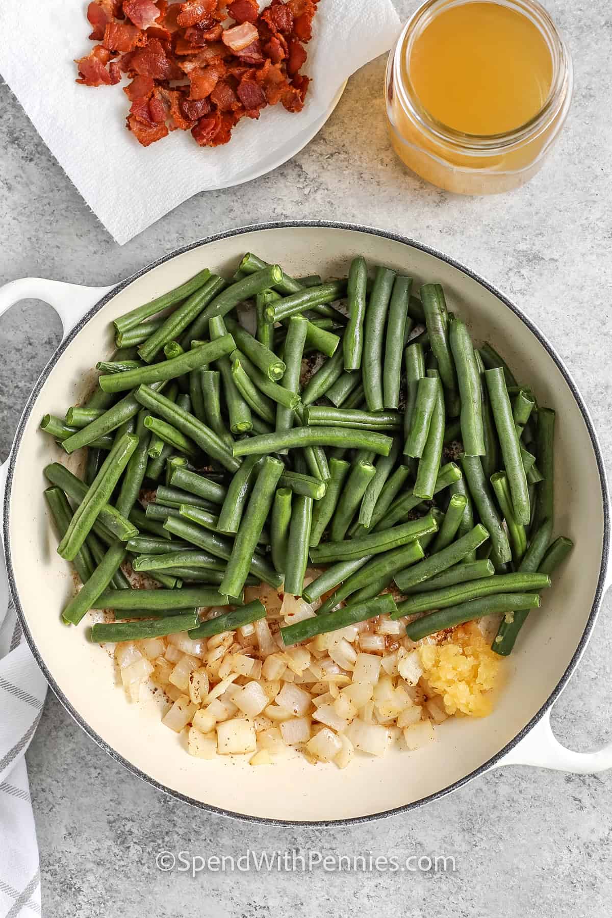 adding green beans , onion and garlic to pan to make Southern Green Beans