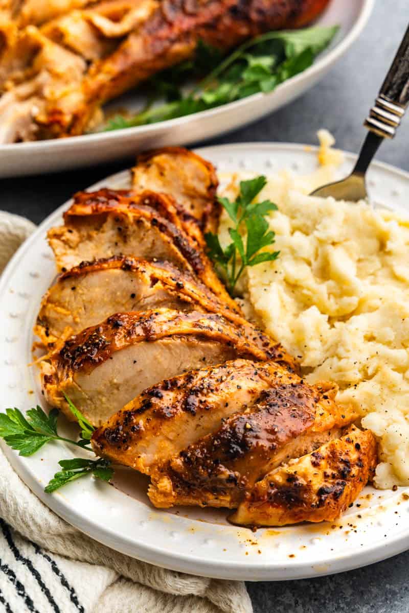 slices of spatchcock turkey on plate with mashed potatoes