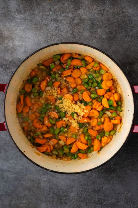 Sautéed vegetables inside a large pot.