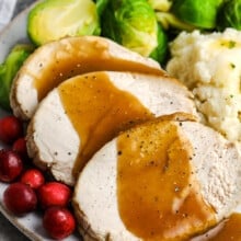 roast turkey breast on a plate with brussels sprouts