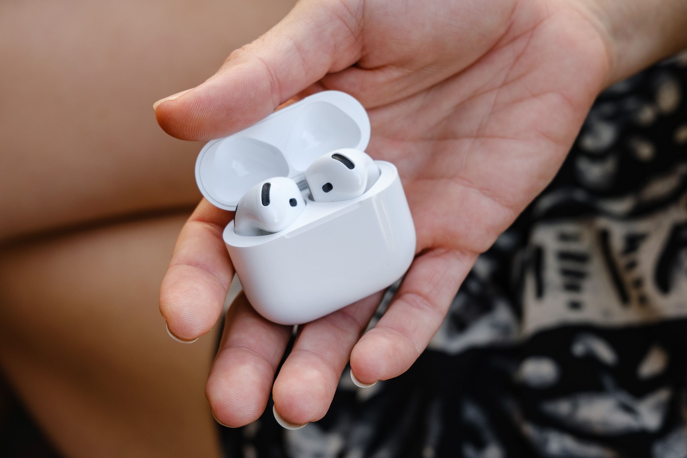 A hands-on photo of Apple’s AirPods 4 wireless earbuds.