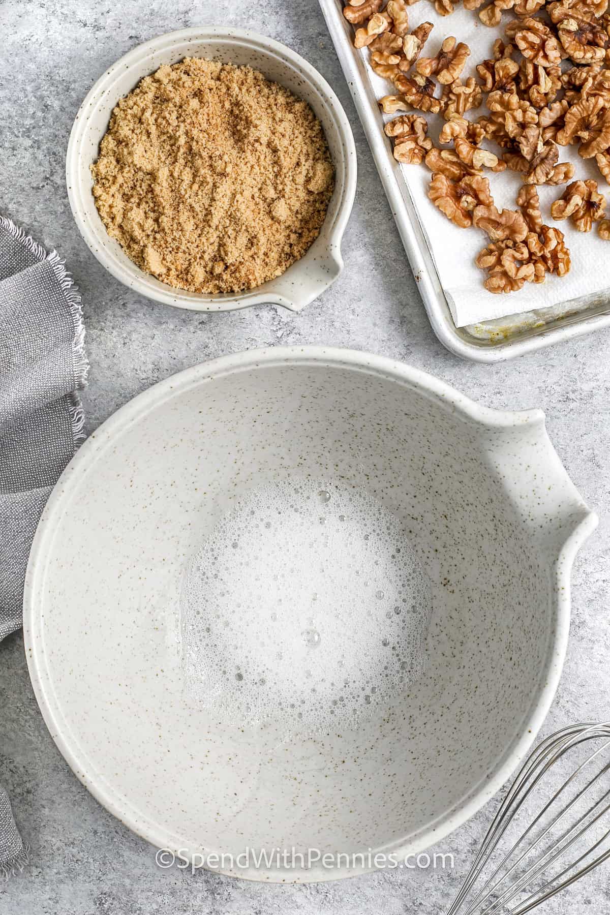 whipped eggs in a bowl to make Candied Walnuts