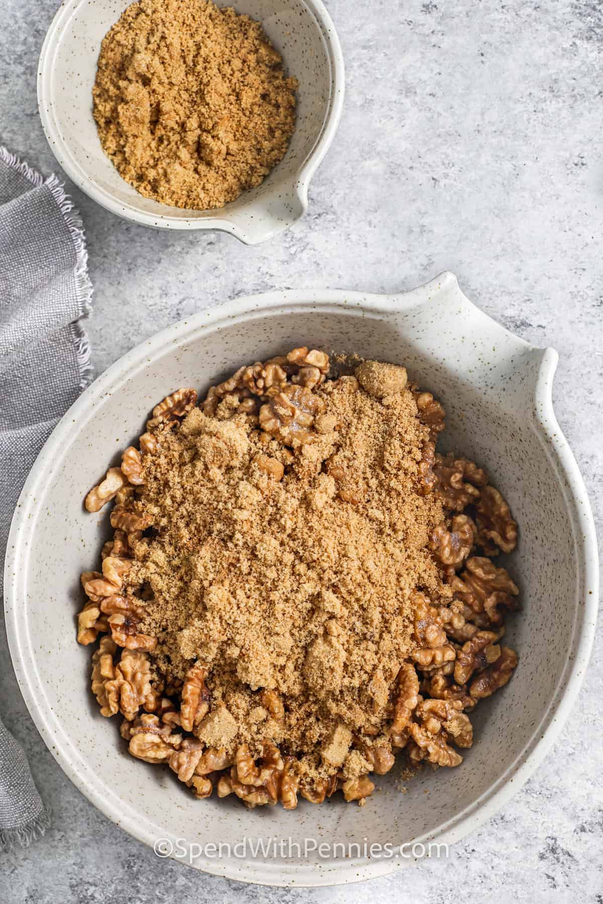 adding brown sugar to walnuts to make Candied Walnuts