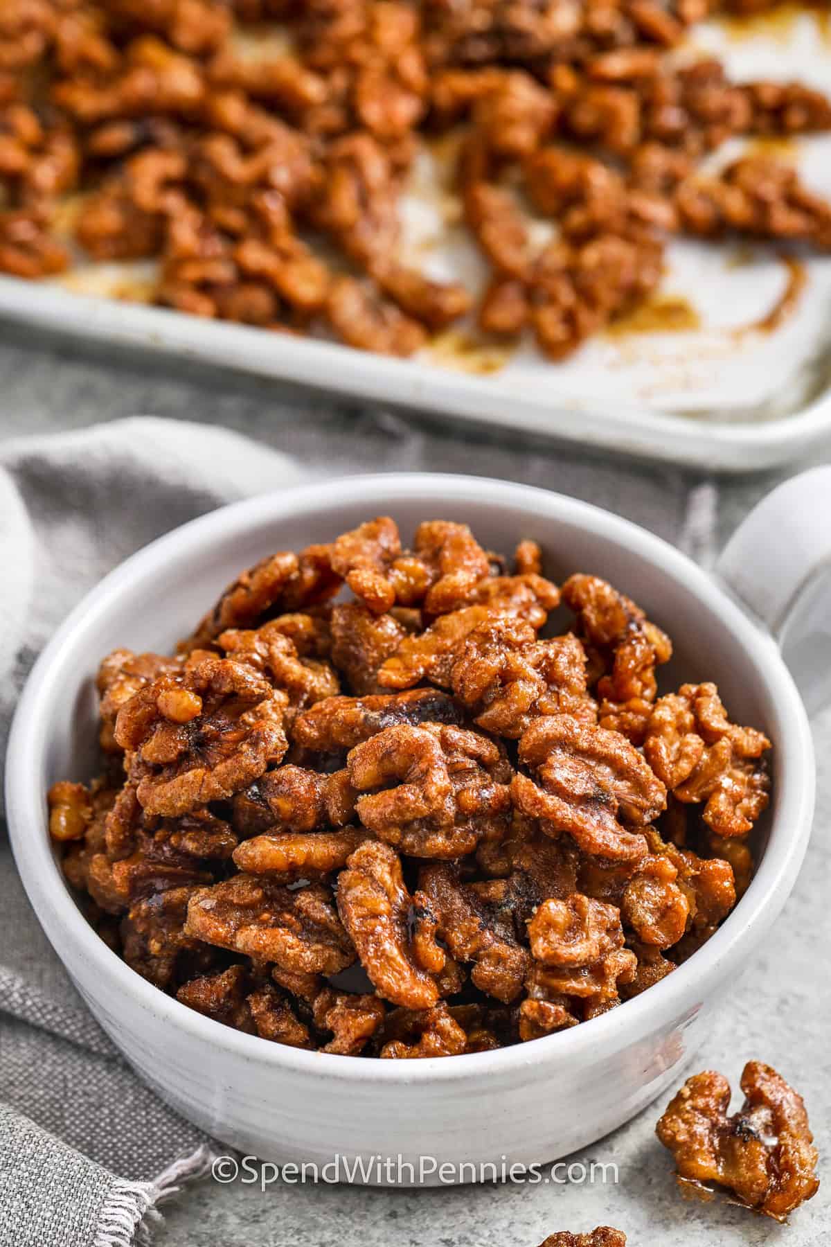 sheet pan of Candied Walnuts and some in a bowl