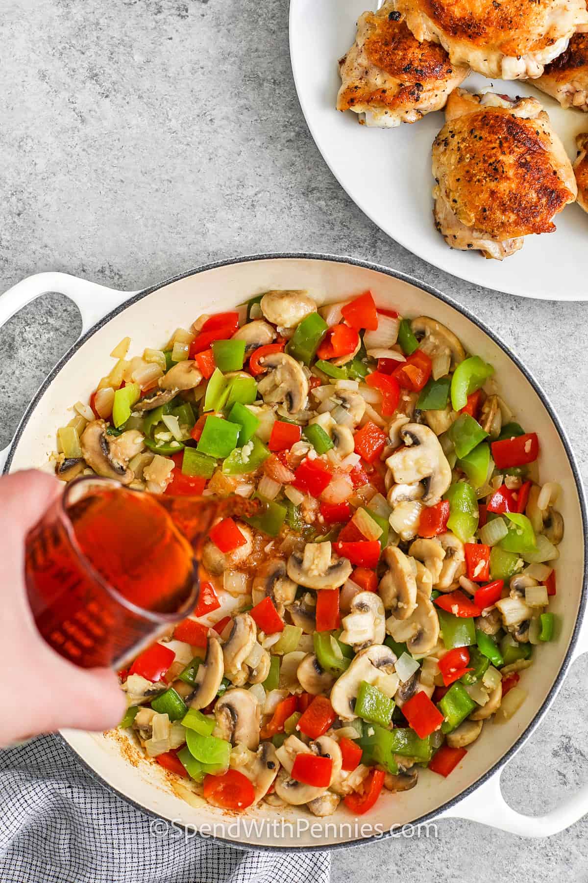 adding liquid to peppers mushrooms and onion to make sauce for Chicken Cacciatore