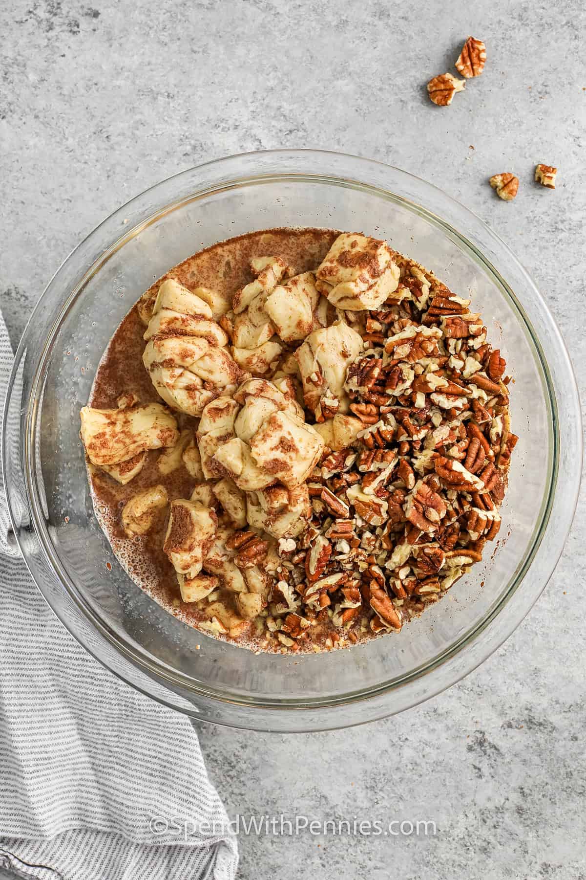 adding ingredients to bowl to make Cinnamon Roll French Toast Casserole