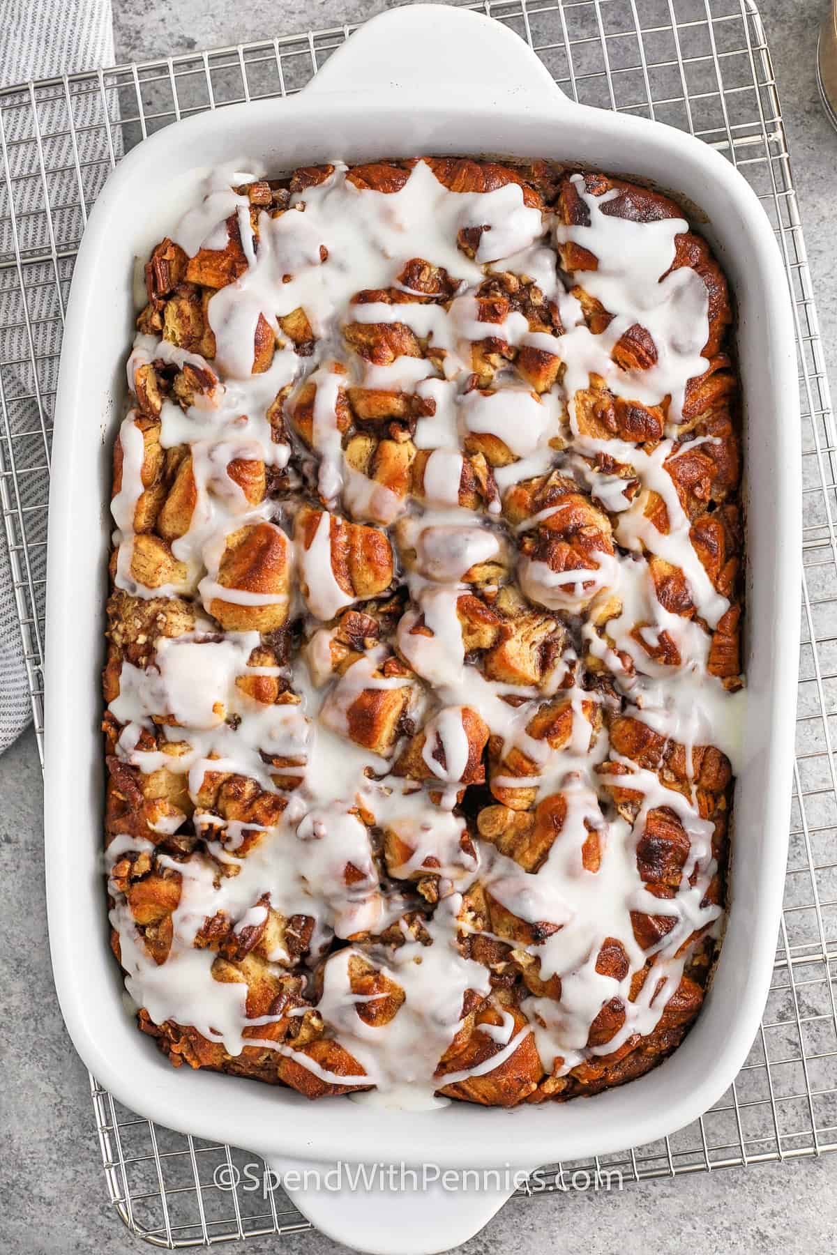 Cinnamon Roll French Toast Casserole in a casserole dish on a cooling rack