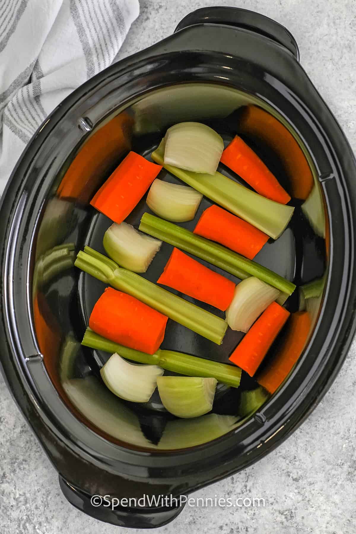 veggies in the bottom of a crockpot for Crockpot Turkey Breast