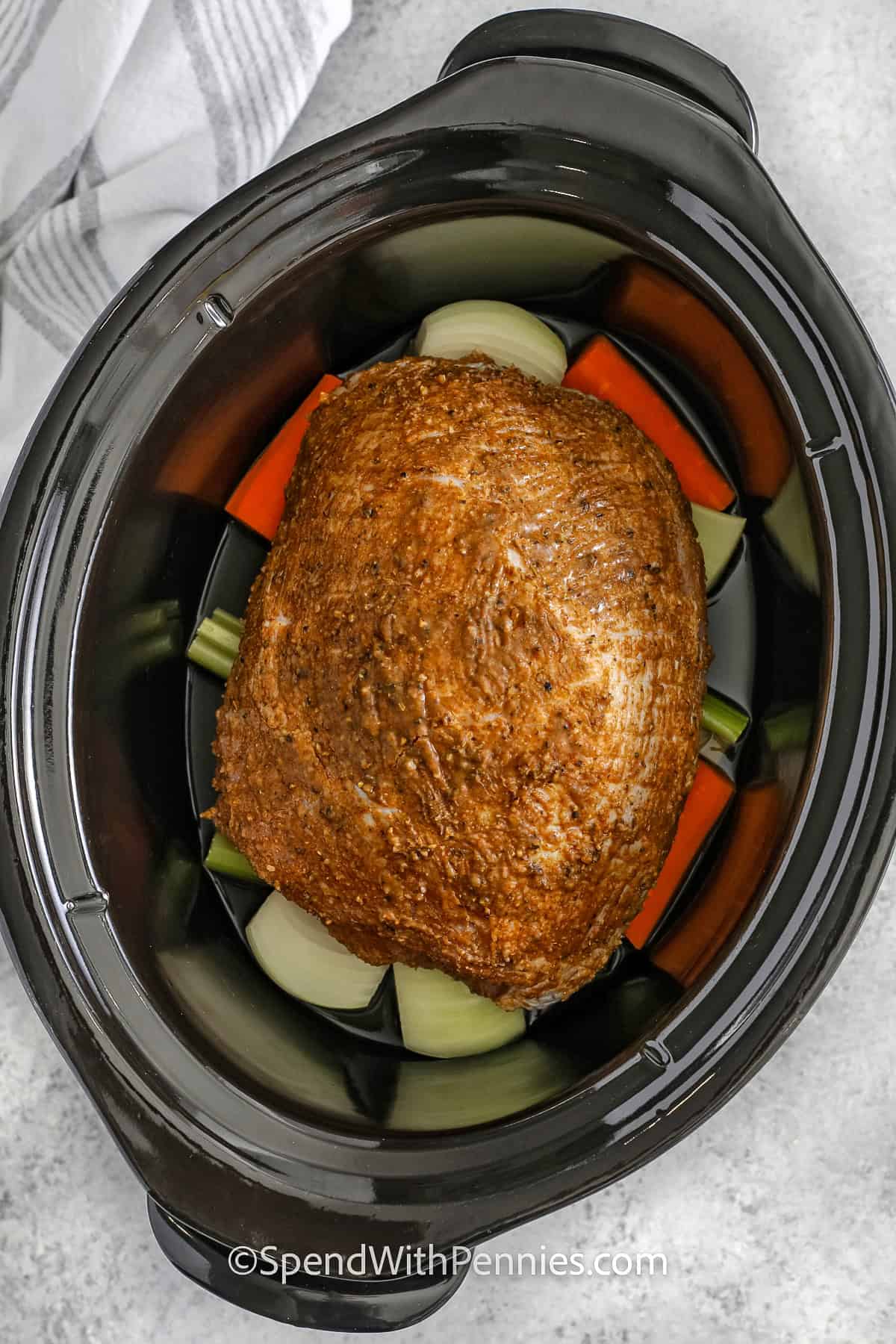 veggies and seasoned turkey in a crockpot for Crockpot Turkey Breast