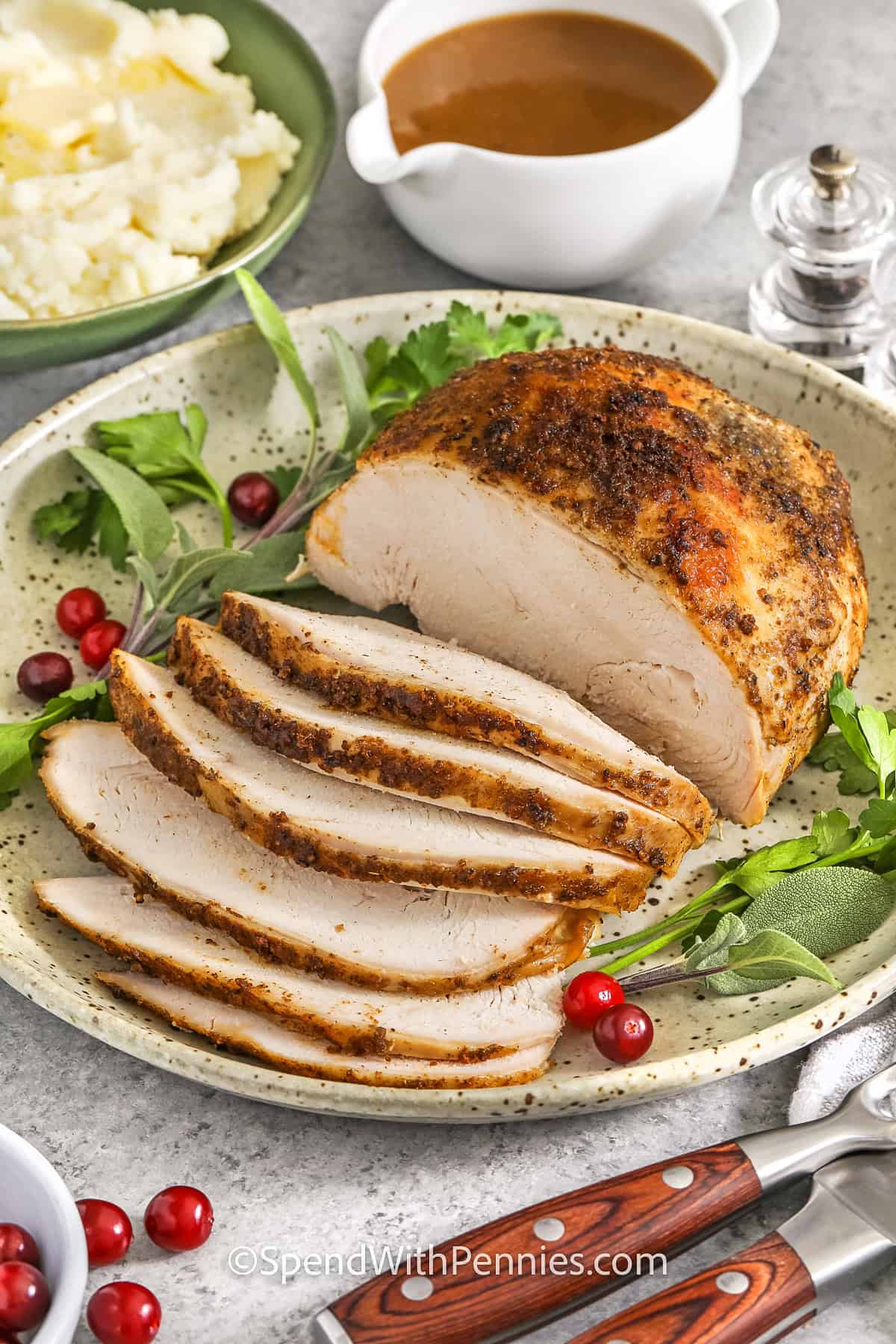 turkey breast on a plate with garnish for Crockpot Turkey Breast