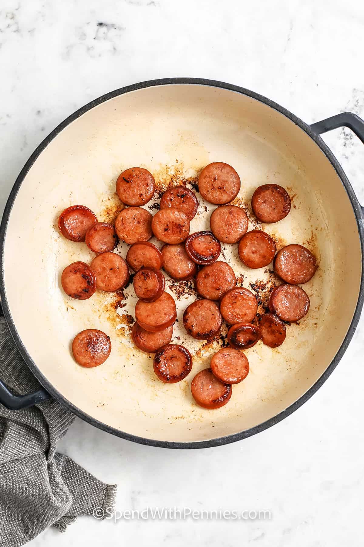 cooking sausage to make Easy Ravioli with Tomato Sauce