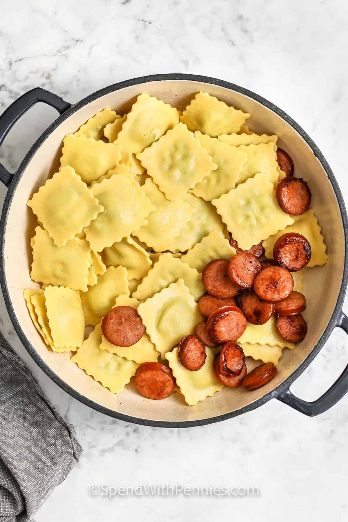 adding sausage to ravioli to make Easy Ravioli with Tomato Sauce