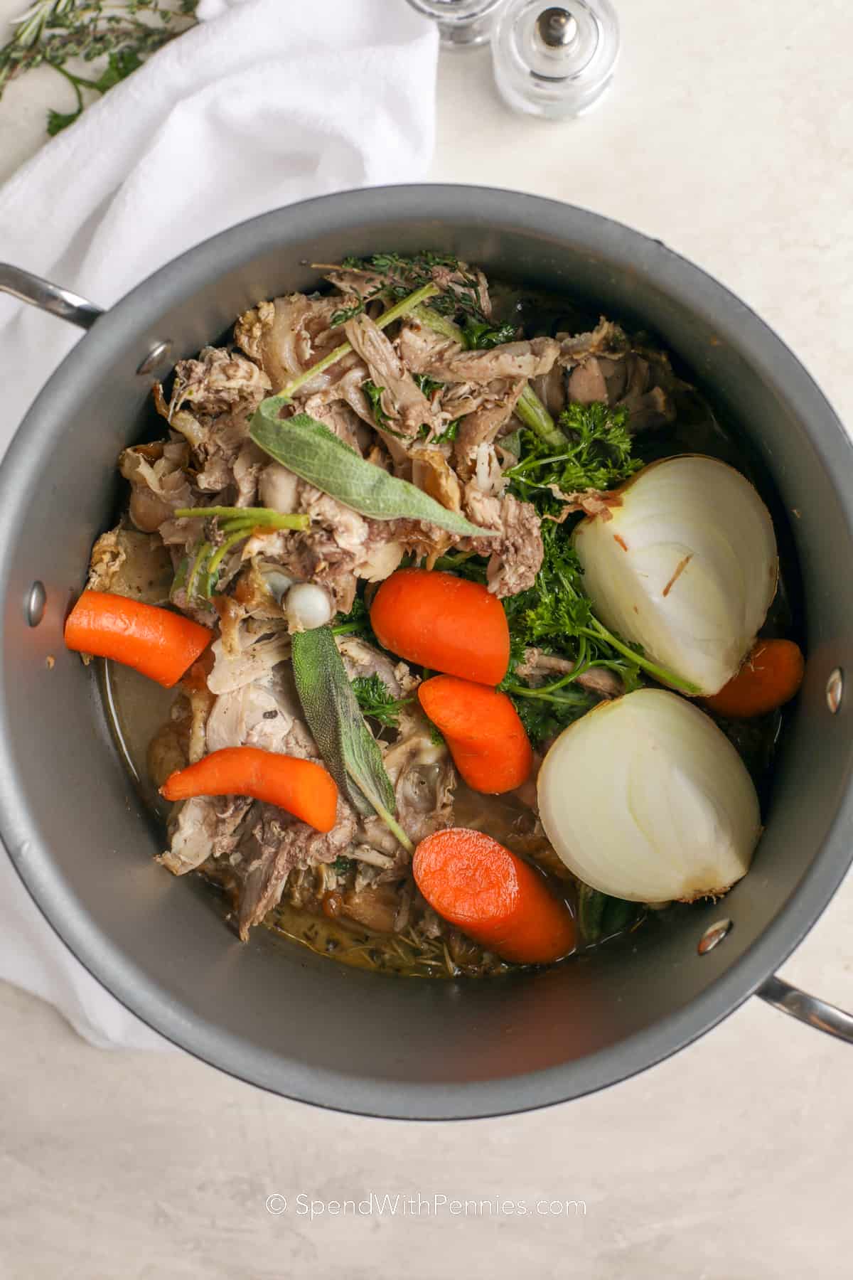 bones and vegetables for turkey noodle soup in a pot