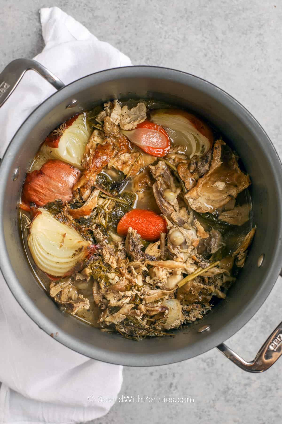 cooked bones and vegetables for turkey noodle soup in a pot