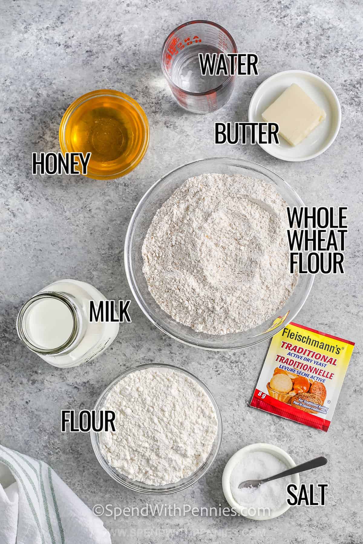 water , honey , butter , whole wheat flour , flour , milk , yeast and salt with labels to make Whole Wheat Bread