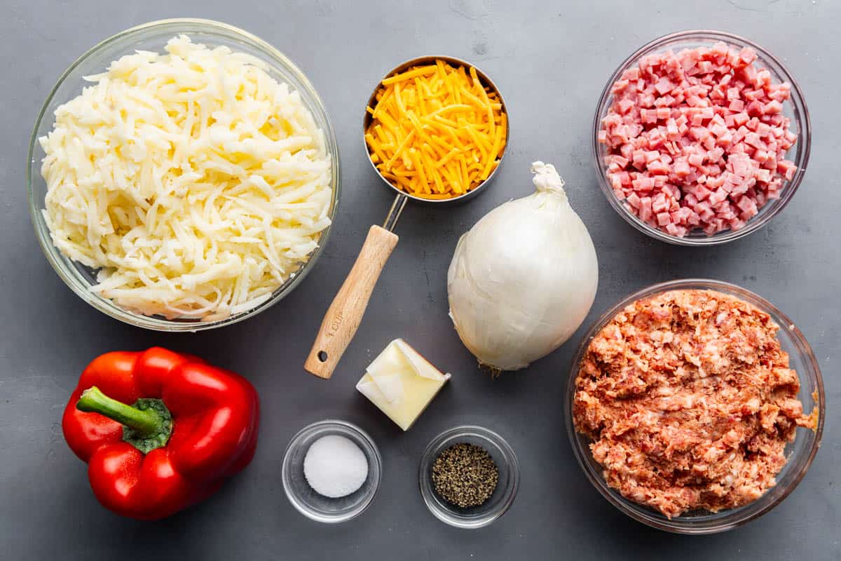 An overhead view of raw and measured ingredients needed to make loaded breakfast hash.