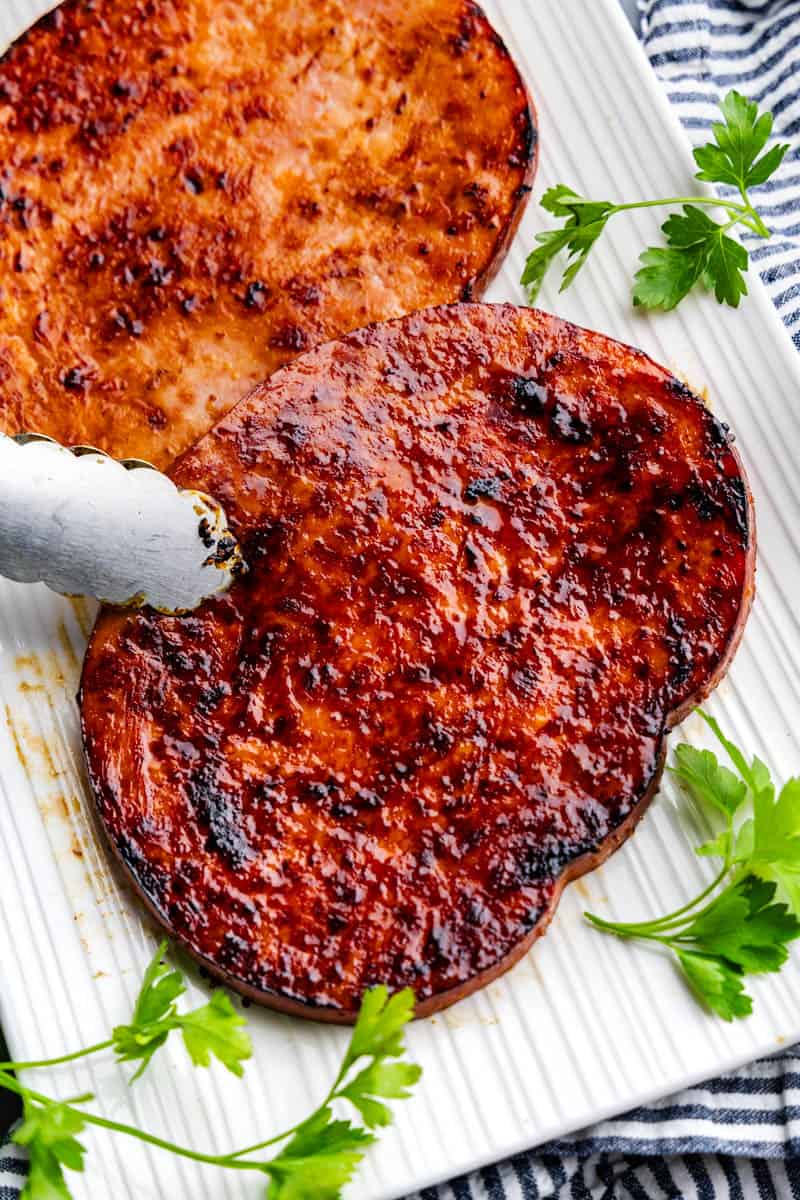 perfectly grilled slice of ham steak covered in maple mustard glaze