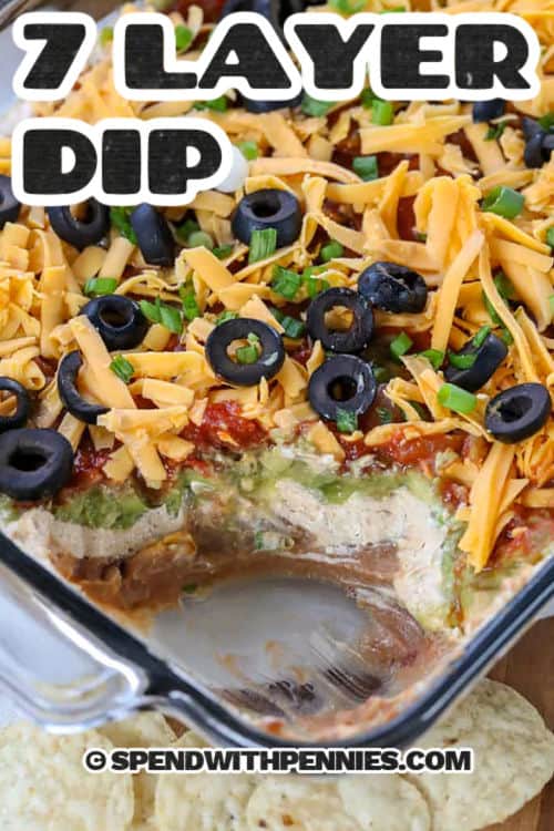 casserole dish of 7 Layer Dip with a title